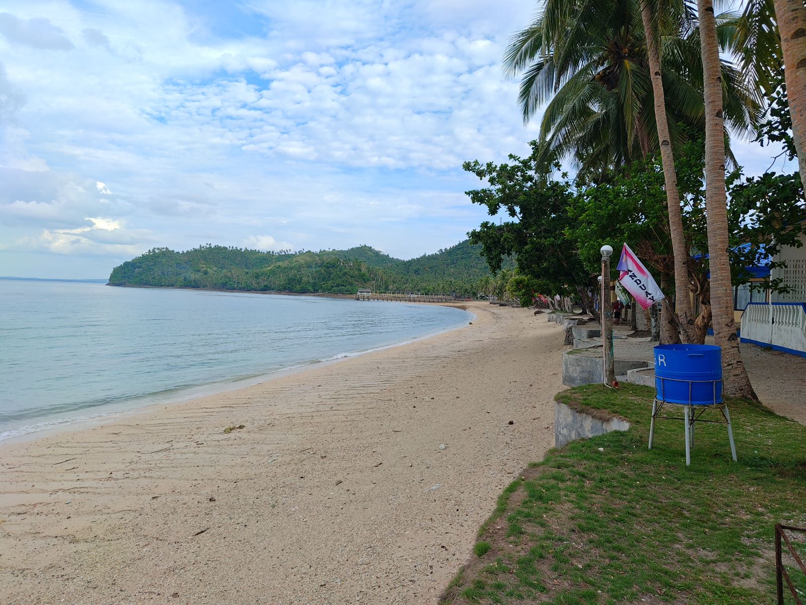Bituon Beach, Mobo — palms and a banca on the shore